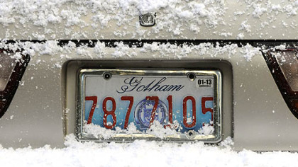 Snow-covered cars on Oliver Avenue sport Gotham license plates as "The Dark Knight Rises" films in Downtown Pittsburgh.
