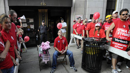 CWA Vice President Thomas Crawford waits for Verizon President and CEO Lowell McAdam, rumored to be coming to speak with hundreds of striking workers gathered outside the company's building on Seventh Avenue, Downtown.