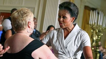 First lady Michelle Obama, right, greets Josephine Grossi, the produce manager of Shop 'N Save in Ambridge, during Wednesday's event on healthy food at the White House.