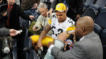 Steelers center Maurkice Pouncey  shows NFL Network's Deion Sanders his injured left ankle during Super Bowl XLV Media Day at Cowboys Stadium in Arlington, Texas Tuesday.
