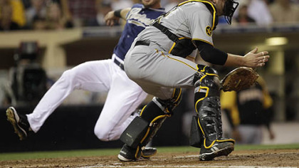Pirates catcher Chris Snyder waits on the late throw as the Padres' Ryan Ludwick slides safely in the third inning Tuesday at Petco Park.