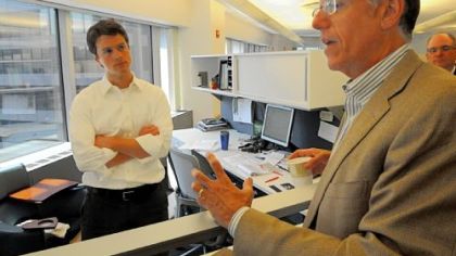 Gary Saulson talks with Benson Gabler, left, about countertop samples.