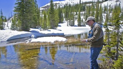 Tom Sabin fishes in Deadhorse Lake in Greenough, Mont., at 7,200 feet, still snowbound in mid-June.