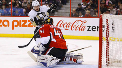 Penguins forward Tyler Kennedy redirects a point shot into the net in behind Senators goaltender Craig Anderson during the first period of tonight's game at Scotiabank Place in Ottawa
