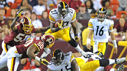 Pittsburgh Steelers Jonathan Dwyer leaps over the Redskins defense picking up a first down in the fourth quarter of Friday's game.
