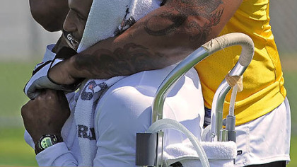 Steelers LaMarr Woodley gets Ryan Mundy in a head lock during a break in workouts at Saint Vincent College. Woodley today signed a $61.5 million contract with the Steelers.