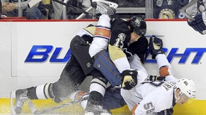 The Penguins' Michael Rupp takes down Edmonton's Jeff Petry,