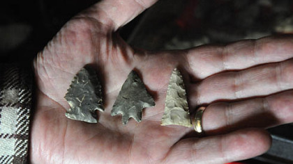 Mike Kotz holds some of his collection of Native American artifacts.