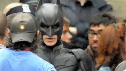 "Batman" speaks with production crew before filming a fight scene for "The Dark Knight Rises" in Oakland.