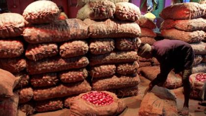 An Indian laborer adjusts onion sacks at a wholesale market in Calcutta. India is urging Pakistan to resume onion exports to help ease the strain of rocketing food prices.