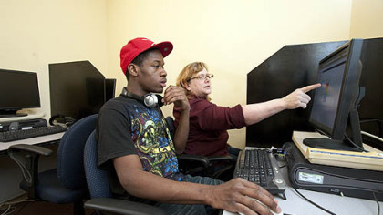 Teacher Susan Guggenheim oversees David Dunbar as he pursues certification in computer repair in a training room at NTR.