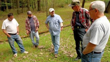 Fred Fletcher, second from right, talks with members of the Sykesville Hunting Club, from left, Larry Righi, Douglas Righi, Tony Zaffuto, and Tom Elkin, about the contamination of the natural spring at the club in Clearfield County. The spring at the hunting lodge in Moshannon State Forest was contaminated by a frac water spill in the summer of 2009.