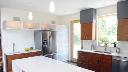 The kitchen continues the metal and wood theme of the exterior.