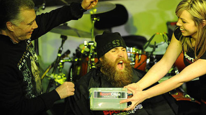 Steelers executive Art Rooney II shears the first hunk of hair from Brett Keisel's beard for charity at Diesel on the South Side tonight with help from Katie Lokey of SportClips.