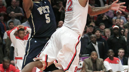 St. John's Dwight Hardy scores the game-winning basket as Pitt's Gilbert Brown defends late in the second half of Saturday's game at Madison Square Garden in New York.