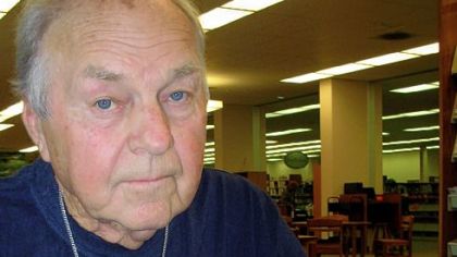 In this 2007 photo, Marshall Grant poses with a copy of his book, "I Was There When It Happened: My Life with Johnny Cash," in Hernando, Miss.