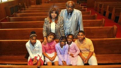 Dorothy Jean Guy and her husband Daniel stand behind their grandchildren, from left, Lisa, Israel, Egypt, Destiny and Jonathan, at their church in Braddock on Sunday. Ms. Guy's grandson Danny is not pictured.