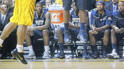 Travon Woodall shoots over West Virginia's Casey Mitchell in the second half Monday in Morgantown, W.Va.