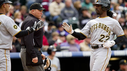 Andrew McCutchen is welcomed home by Ronny Cedeno after Garrett Jones' two-run single Sunday.