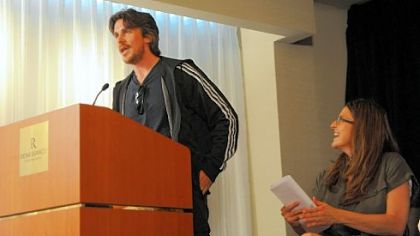 Dawn Keezer, right, director of the Pittsburgh Film Office, listens as actor Christian Bale speaks at Thursday's news conference.