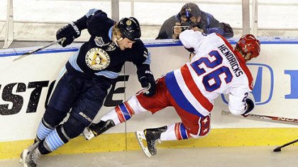 The Penguins' Jordan Staal checks Capitals Matt Hendricks along the boards in the first period at the Winter Classic at Heinz Field last night.