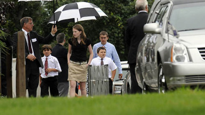 Mourners arrive for the funeral service for flood victims Kimberly, Brenna and Mikaela Griffith.