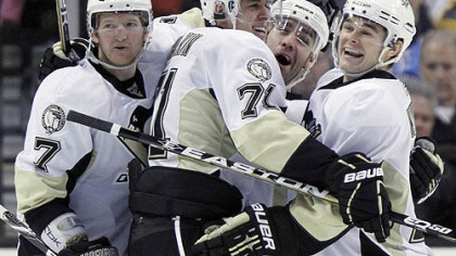 Penguins forward Pascal Dupuis celebrates a goal with teammates Paul Martin, Evgeni Malkin and Chris Kunitz in the second period of Saturday's game against the Bruins at TD Garden in Boston.