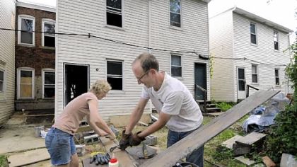 Emily and Sten Carlson on Thursday work on refurbishing the rowhouse they have purchased on Black Street in East Liberty.
