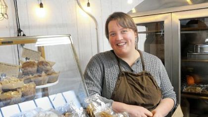 Sara Kelby Lewis, the owner/baker for Sustenance Rustic Craft Bakery, at her stand in the Pittsburgh Public Market.