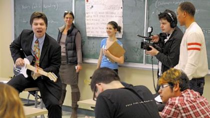 Pittsburgh CAPA student David Becinski shoots video of 12th-grade English teacher Jim Addlespurger playing guitar and singing as he teaches Shakespeare and The Blues. Viacom's Tony Anderson, right, looks over David's shot. CAPA students are making a video about their school as part of a competition to have President Barack Obama as their commencement speaker.