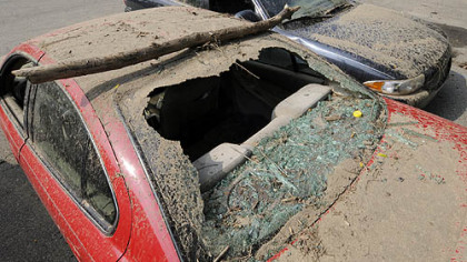 Mud-covered vehicles destroyed Friday in flooding on Washington Boulevard await their fate at the Pittsburgh Police Zone 5 Station.