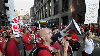 CWA representative Michael Sosak rallies hundreds of striking Verizon workers outside the company's building on Seventh Avenue, Downtown.
