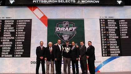 The Penguins drafted defenseman Joe Morrow, center, in the first round of last month's draft with was hosted at the Xcel Energy Center in St. Paul, Minn.