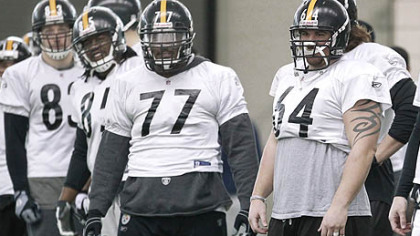 Steelers center Doug Legursky (64), guard Dorian Brooks (77), and other linemen listen to a coach during practice on Friday in Fort Worth, Texas.