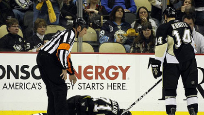 Penguins forward Chris Kunitz skates towards teammate Evgeni Malkin who lies injured on the ice during the second period of Friday's 3-2 win against the Sabres at Consol Energy Center.