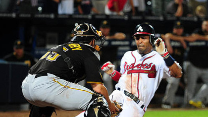 The Braves' Julio Lugo scores the game-winning run in the 19th inning against Pirates catcher Mike McKenry at Turner Field in Atlanta Tuesday. McKenry appeared to make the tag before Lugo touched the plate but umpire Jerry Meals called him safe.


MLB video: Watch a replay of the final play
