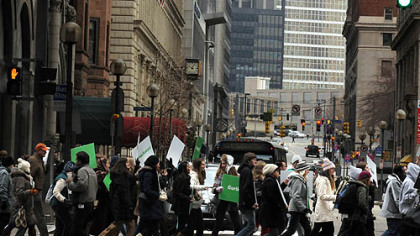 The Pittsburgh Darfur Emergency Coalition and Partners cross at the intersection of Wood Street and Sixth Avenue to Market Square during an organized "March and Rally for Peace in Sudan."