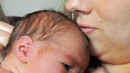 Melissa Bungar and her newborn daughter are practicing a nurturing concept known as "kangaroo care," which emphasizes skin contact between mother and child.