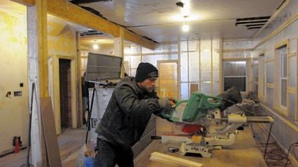 Chris Rhodes of West Penn Energy Solutions renovates an old house in East Liberty on Friday.