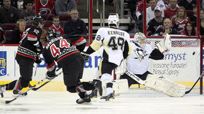 Hurricanes defenseman Jay Harrison fires the puck into the net past Penguins goalie Marc-Andre Fleury during the first period of Friday's game at RBC Center in Raleigh, N.C.