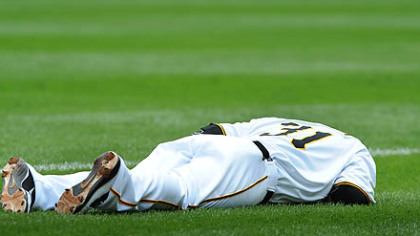 Jose Tabata lies on the field after being injured while beating out a first-inning bunt.