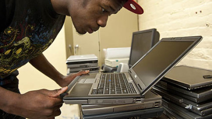 David Dunbar performs the final inspection of a laptop that will be sold by Nonprofit  Technology Resources.