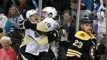 Penguins forward Dustin Jeffrey, center, celebrates his overtime goal with teammate Tyler Kennedy as Bruins foraward Chris Kelly looks away during following Saturday's game at TD Garden in Boston.