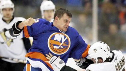 New York Islanders' Micheal Haley, left, and the Penguins' Craig Adams fight in the first period of Friday's game in Uniondale, N.Y. Both players drew penalties.