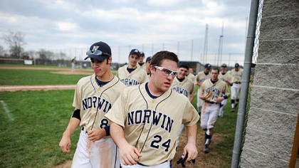 Norwin High School baseball player Rocco Amendola runs back to the dugout with his teammates after congratulating a fellow player on a home run.