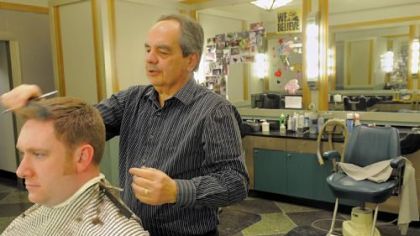 Ron DeMutis gives Damien Gottschalk of Whitehall a haircut in the Koppers Building barbershop.