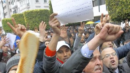 Protesters display bread during a demonstration against the Constitutional Democratic Rally party of deposed President Zine El Abidine Ben Ali in Tunis.