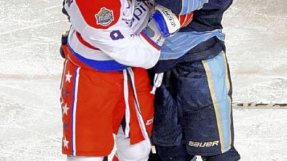 The Capitals' Alexander Ovechkin and the Penguins' Chris Kunitz go at each other near the end of the third period at the Winter Classic at Heinz Field last night.