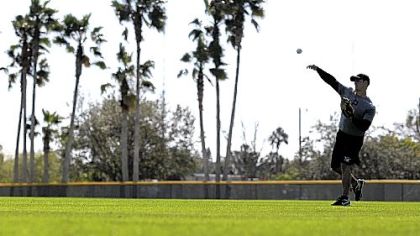 Pirates non-roster player Eric Fryer throws at a voluntary spring training workout Sunday in Bradenton, Fla. Pitchers and catchers begin workouts today.