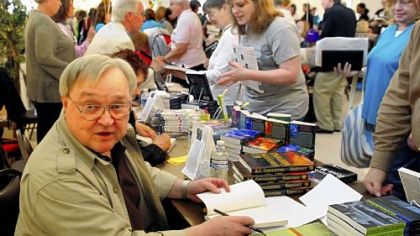 After years of mystery -- and writing them -- author K.C. Constantine appears at Monday's Festival of Mystery in Oakmont and signs his books among a bevy of buyers.